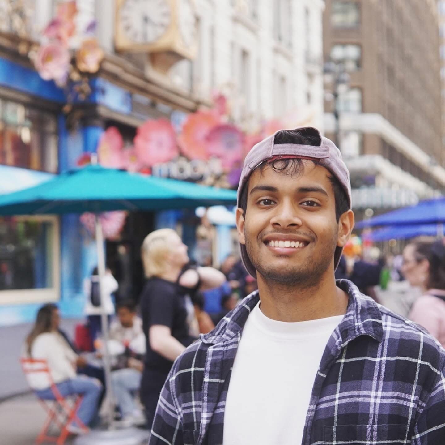 Vedant smiling on a city street